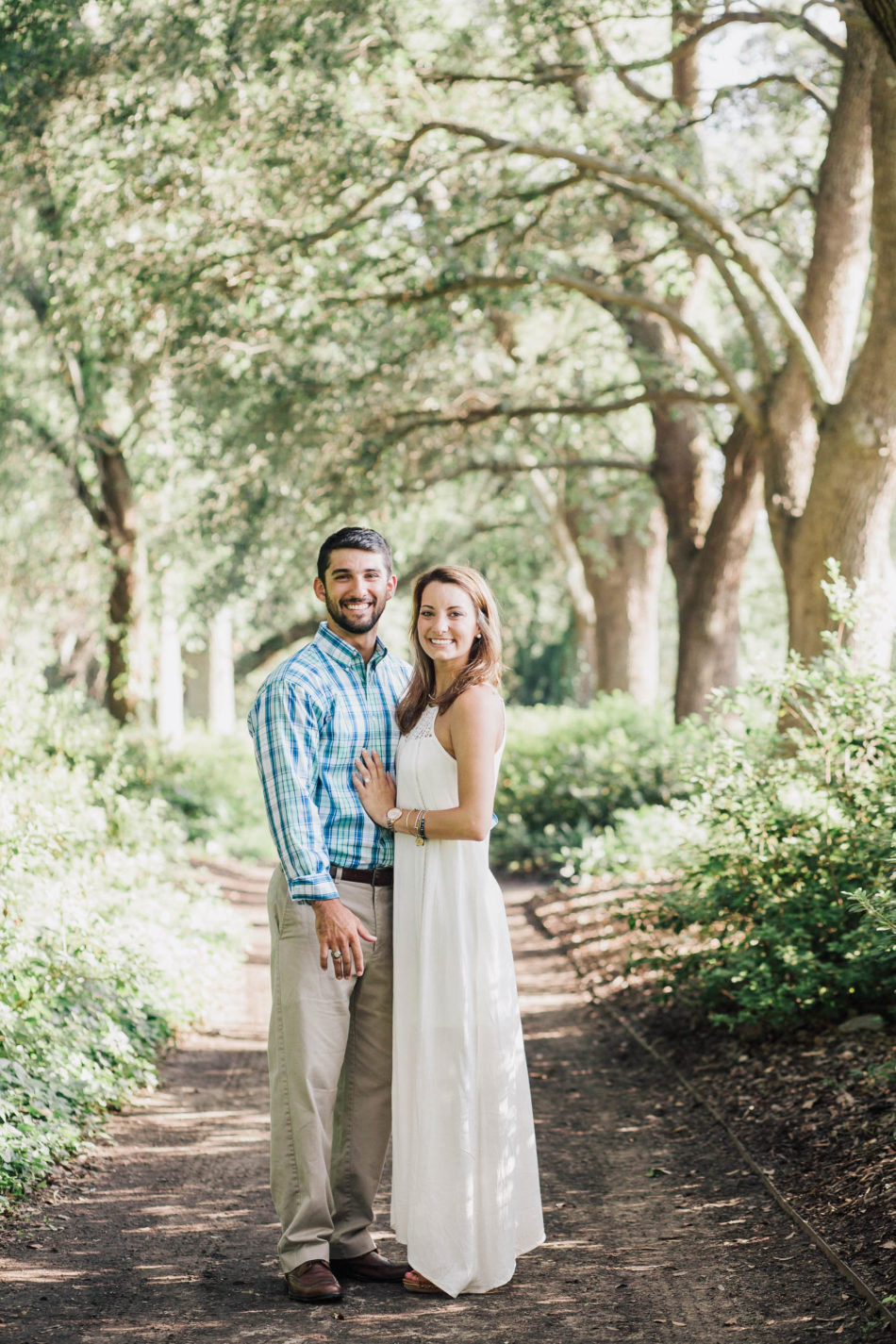Engaged couple stand in path of oak trees, Hampton Park, Charleston, South Carolina Kate Timbers Photography. http://katetimbers.com #katetimbersphotography // Charleston Photography // Inspiration