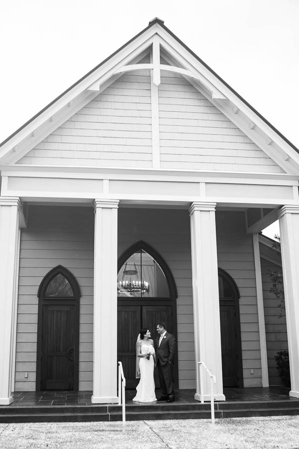Bride and groom stand together, Church of the Holy Cross, Sullivans Island, Charleston, SC, Hurricane Joaquin. Kate Timbers Photography. katetimbers.com