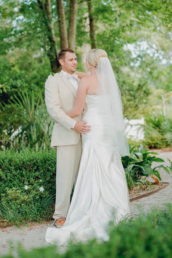 Bride and groom stand among palm trees, Creek Club at I'on, Charleston, South Carolina. Kate Timbers Photography. http://katetimbers.com