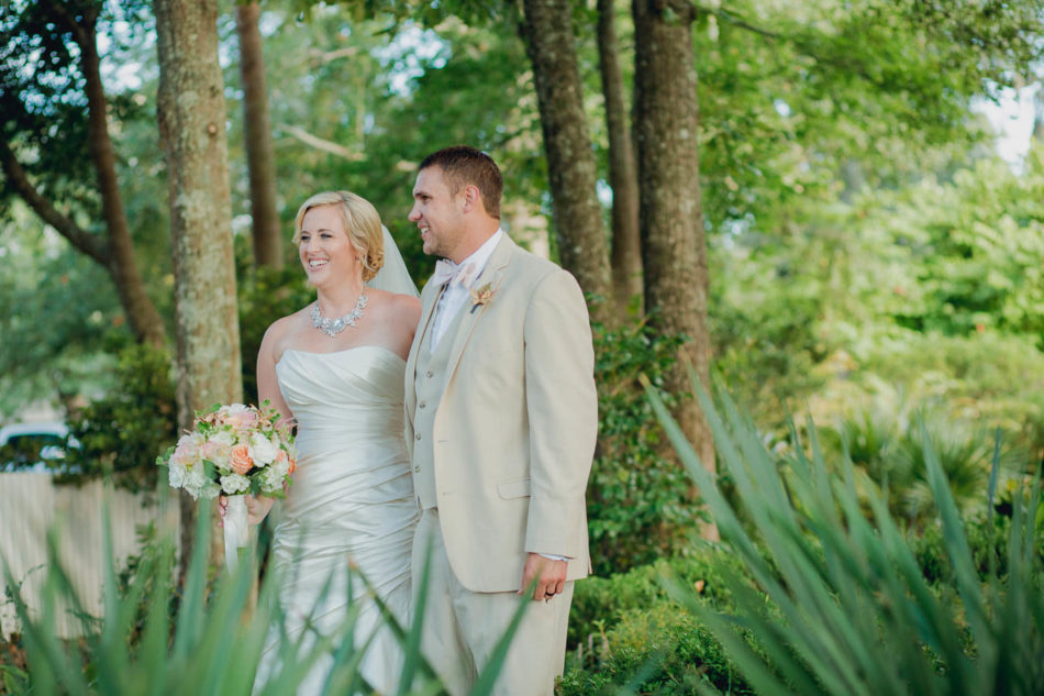 Bride and groom stand among palm trees, Creek Club at I'on, Charleston, South Carolina. Kate Timbers Photography. http://katetimbers.com