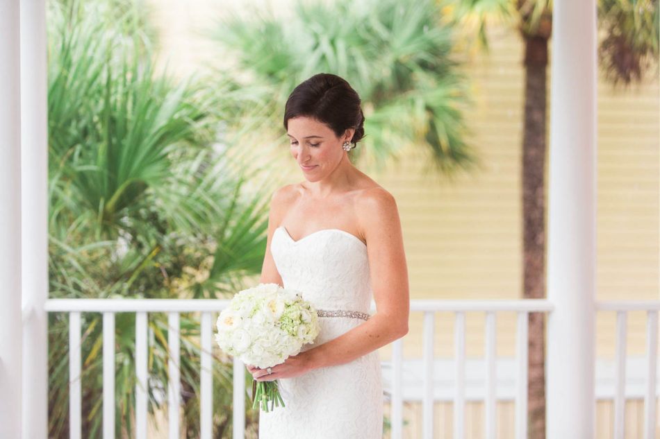 Bride stands on porch, Isle of Palms, Charleston, SC, Hurricane Joaquin. Kate Timbers Photography. katetimbers.com
