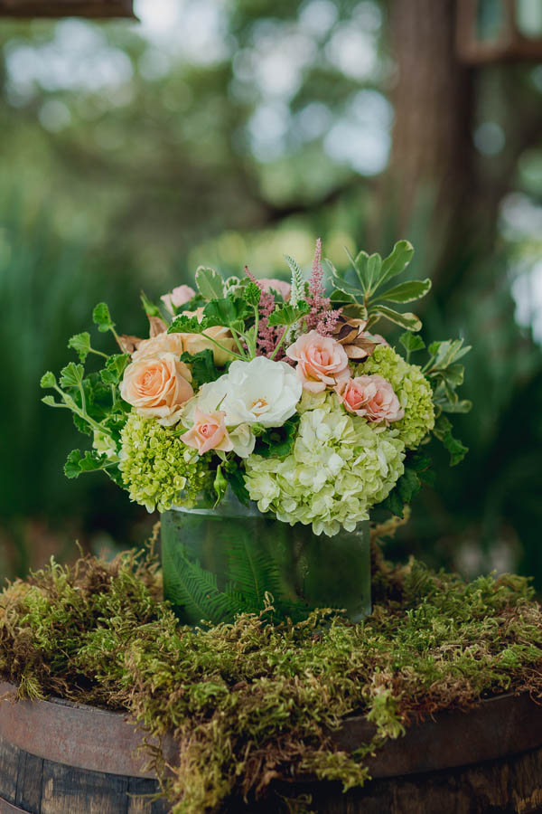 Flowers are set on moss at ceremony site, Creek Club at I'on, Charleston, South Carolina. Kate Timbers Photography. http://katetimbers.com
