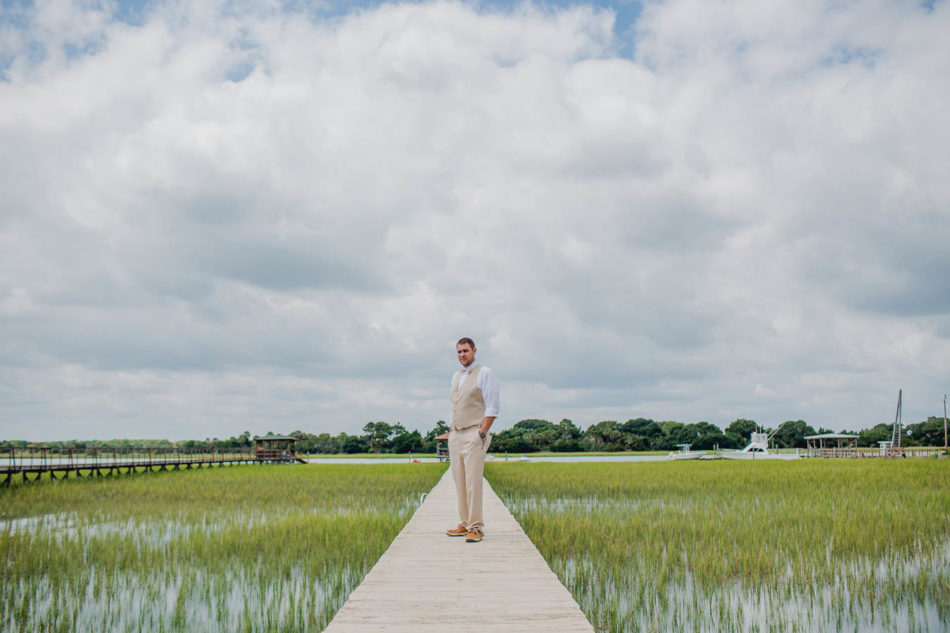 Groom stands on dock in Shem Creek, Creek Club at I'on, Charleston, South Carolina. Kate Timbers Photography. http://katetimbers.com