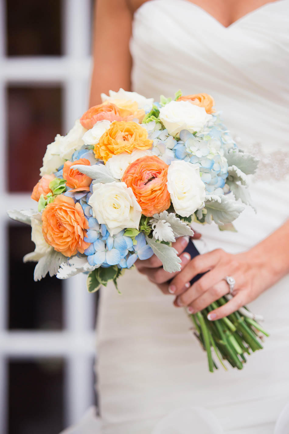 Bouquets have orange and blue flowers, Dunes West Golf and River Club, Mt Pleasant, South Carolina. Kate Timbers Photography. http://katetimbers.com