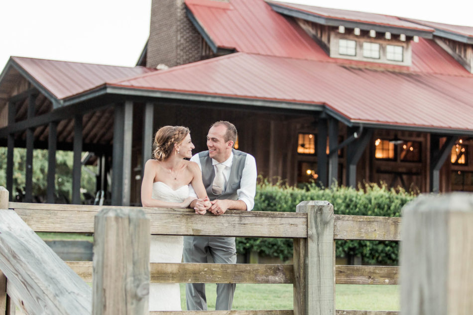 Bride and groom lean on fence, Pepper Plantation, Awendaw, South Carolina. Kate Timbers Photography. http://katetimbers.com