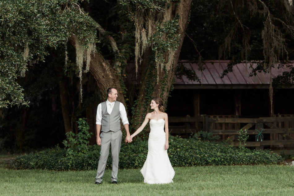 Bride and groom cuddle under an oak tree, Pepper Plantation, Awendaw, South Carolina. Kate Timbers Photography. http://katetimbers.com