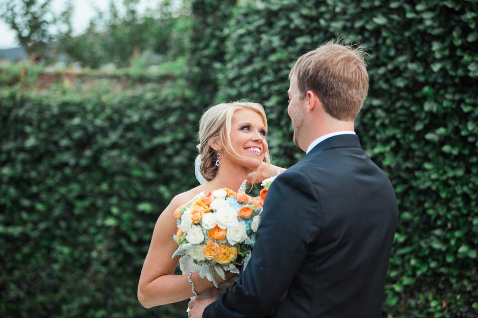 Bride and groom smile by ivy covered wall for this Charleston wedding at Dunes West Golf and River Club, Mt Pleasant, South Carolina. Kate Timbers Photography. http://katetimbers.com