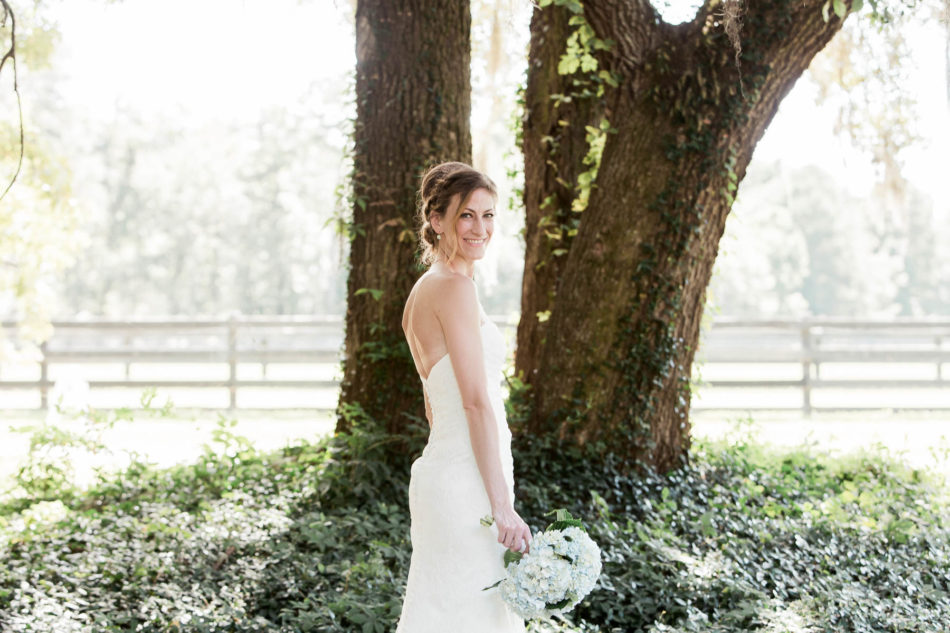 Bride poses under the oak tree, Pepper Plantation, Awendaw, South Carolina. Kate Timbers Photography. http://katetimbers.com
