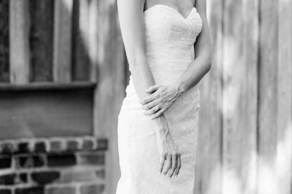 Bride poses by rustic barn, Pepper Plantation, Awendaw, South Carolina. Kate Timbers Photography. http://katetimbers.com