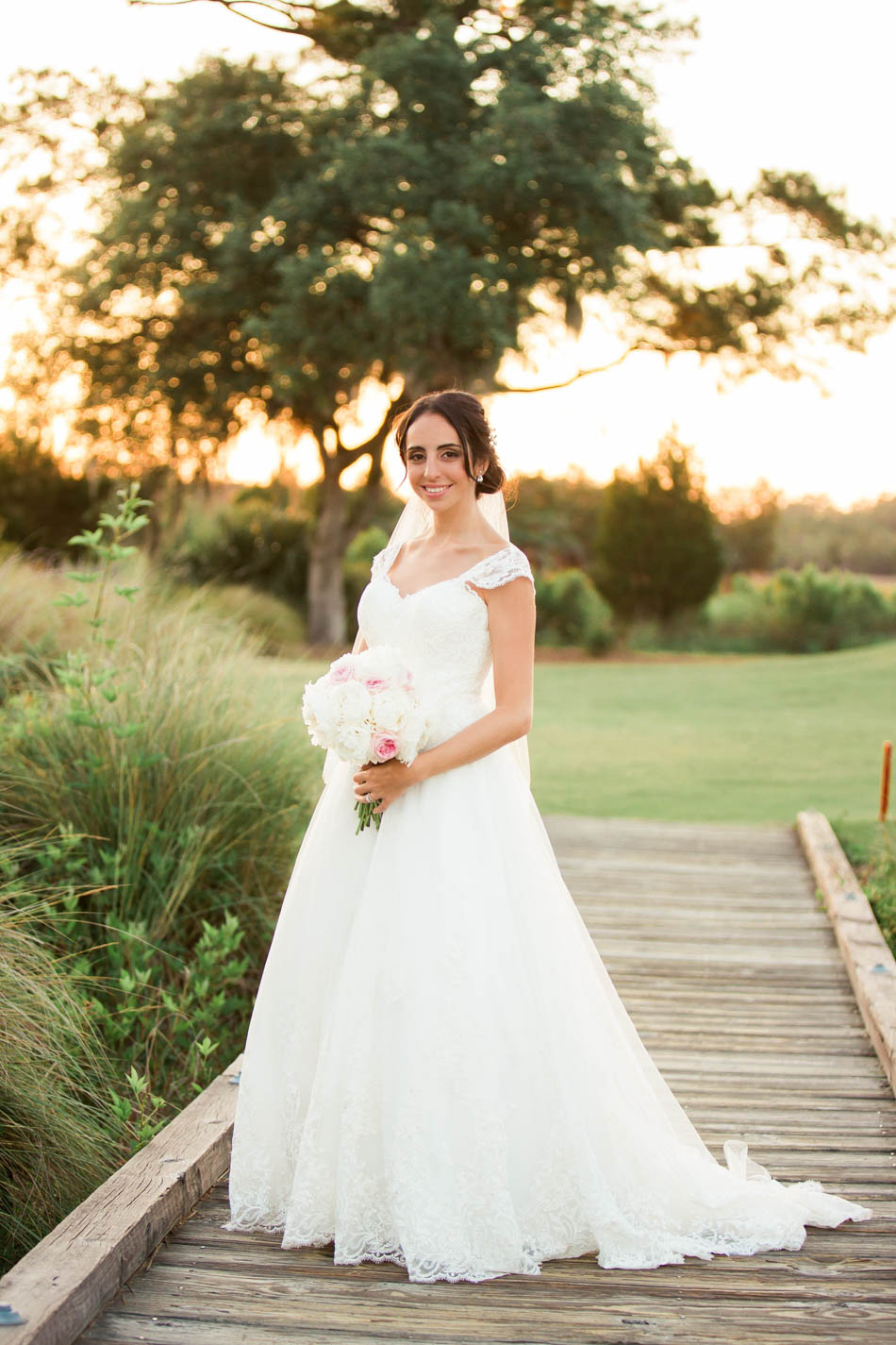 Bride stands on a dock at sunset, Daniel Island Club. Kate Timbers Photography. http://katetimbers.com