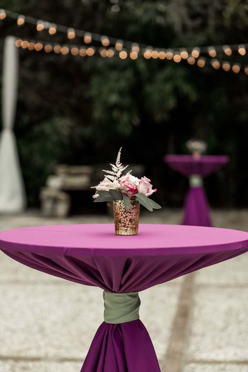 Flowers are set on purple cocktail tables, Magnolia Plantation. Kate Timbers Photography. http://katetimbers.com