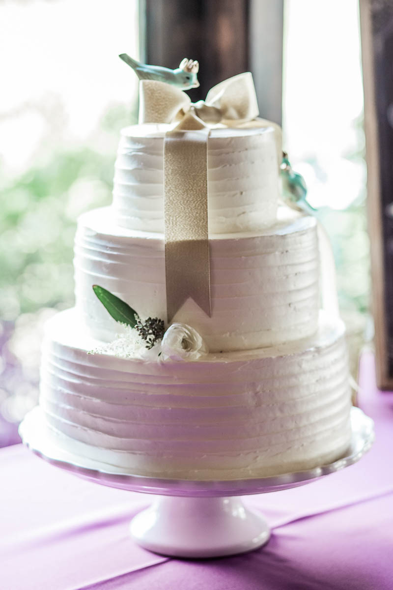 A white cake has bird toppers, Magnolia Plantation. Kate Timbers Photography. http://katetimbers.com
