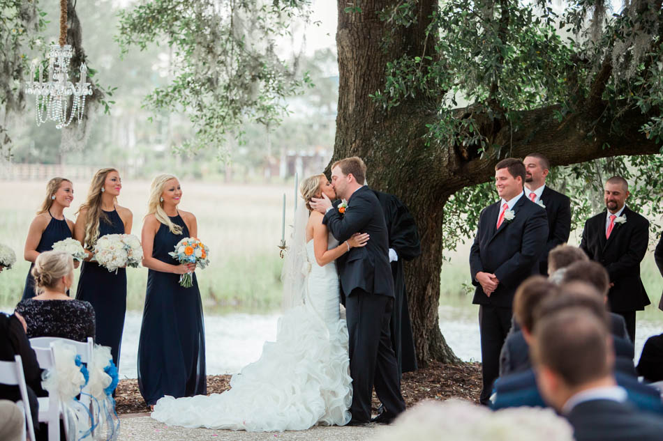 Bride and groom kiss under an oak tree, Dunes West Golf and River Club, Mt Pleasant, South Carolina. Kate Timbers Photography. http://katetimbers.com