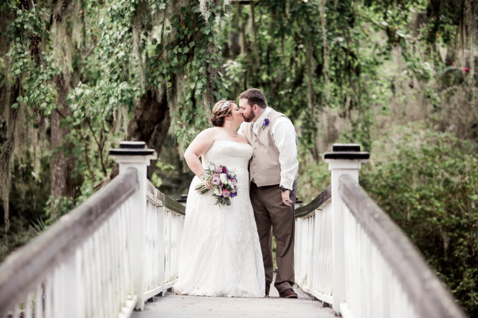 Bride and groom stand on white bridge, Magnolia Plantation. Kate Timbers Photography. http://katetimbers.com