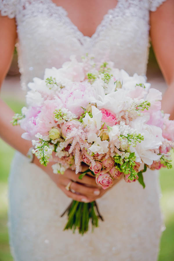 Bride holds pink, white, and green bouquet arranged by Wildflowers Inc, College of Charleston Cistern, South Carolina. Kate Timbers Photography. http://katetimbers.com