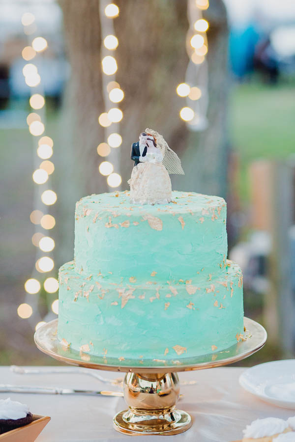 Gold and green cake is placed on a table with vintage cake topper, James Island Yacht Club, Charleston, South Carolina. Kate Timbers Photography. http://katetimbers.com