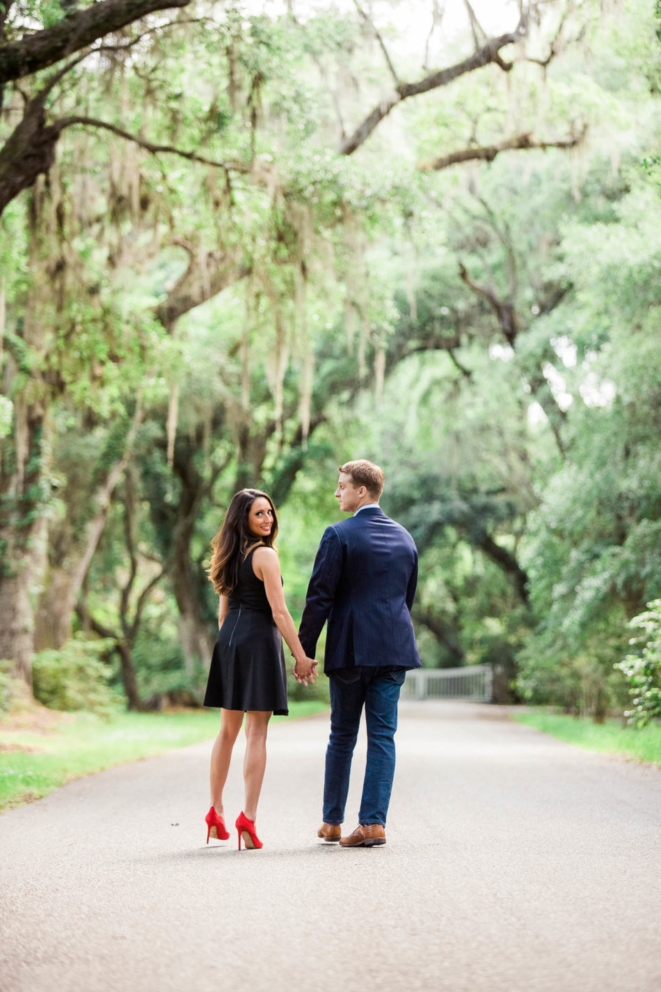 Engaged couple walks down road to the Avenue of Oaks, Magnolia Plantation, Charleston, South Carolina. Kate Timbers Photography. http://katetimbers.com