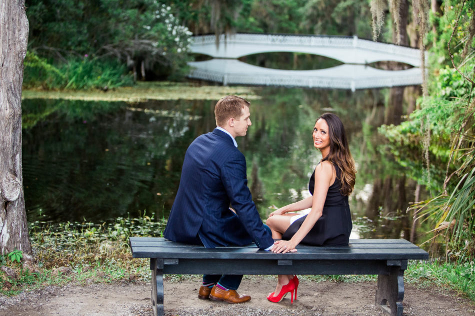 Engaged couple sit on a bench by the white bridge, Magnolia Plantation, Charleston, South Carolina. Kate Timbers Photography. http://katetimbers.com