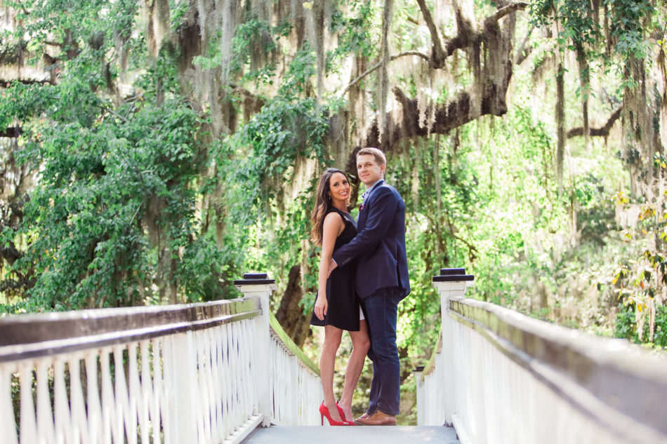 Engaged couple stand on a white bridge, Magnolia Plantation, Charleston, South Carolina. Kate Timbers Photography. http://katetimbers.com