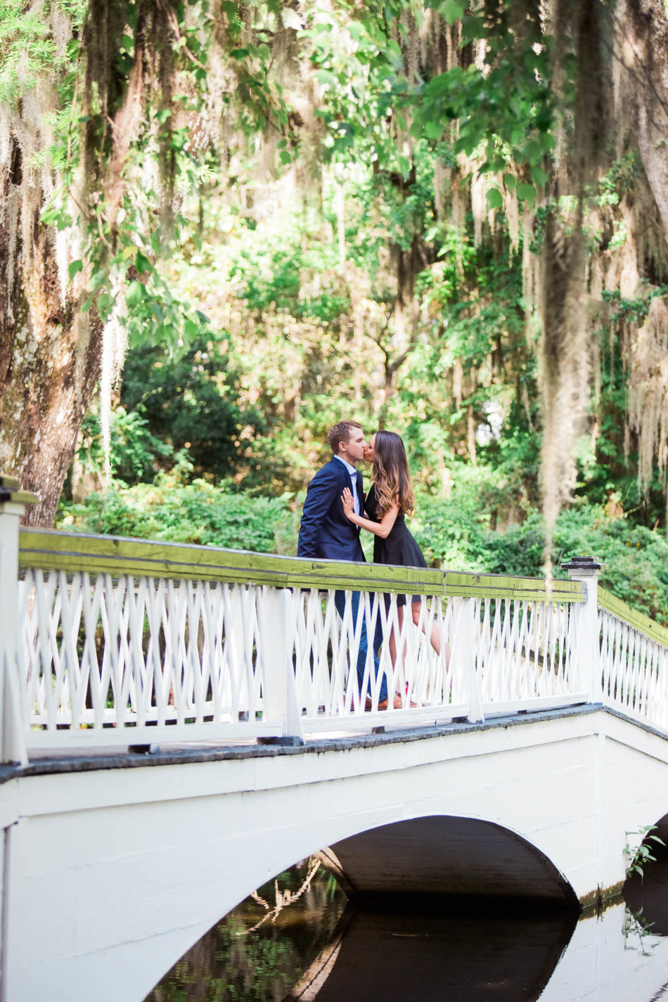 Engaged couple stand on a white bridge, Magnolia Plantation, Charleston, South Carolina. Kate Timbers Photography. http://katetimbers.com