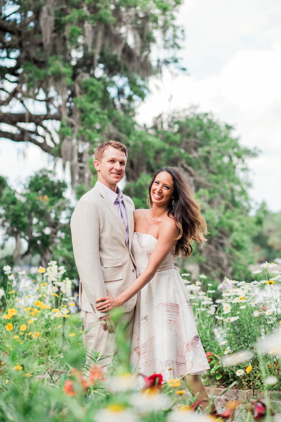 Engaged couple stand among wildflowers, Magnolia Plantation, Charleston, South Carolina. Kate Timbers Photography. http://katetimbers.com