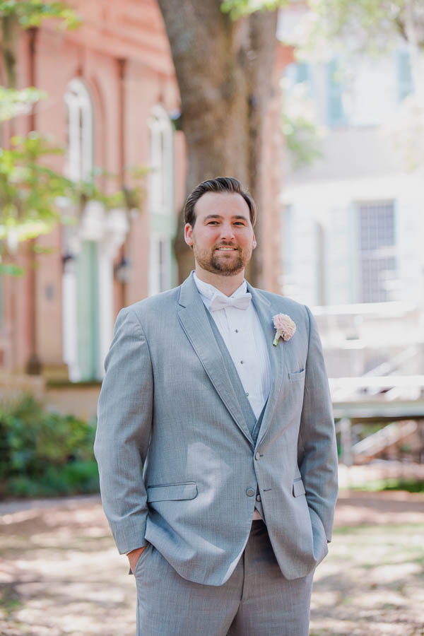 Groom stands at College of Charleston Cistern, South Carolina. Kate Timbers Photography. http://katetimbers.com