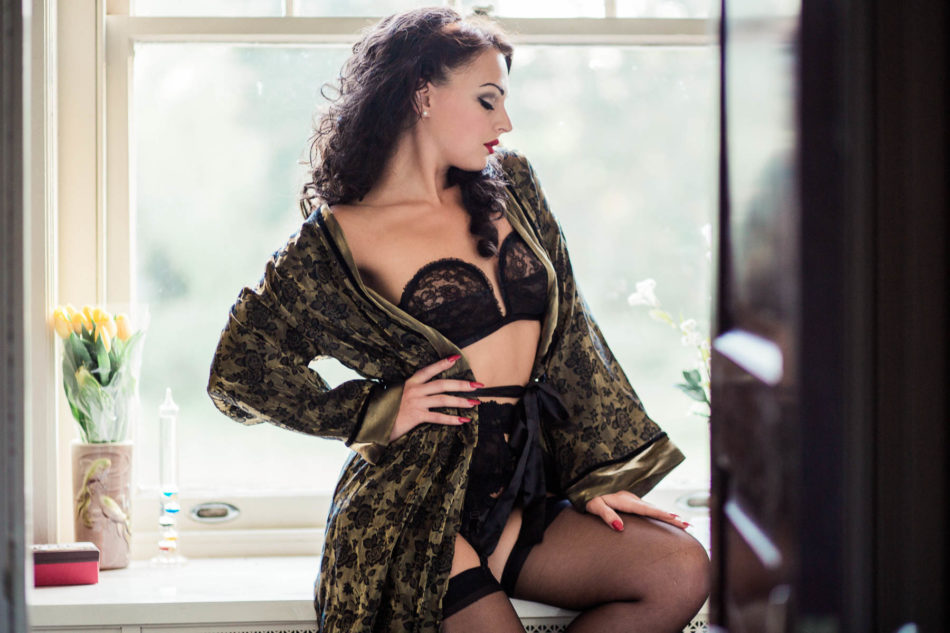 Ms A wears a retro green silk robe and lacy black lingerie outfit with stockings and heels, Boudoir Photography, Charleston, SC. Kate Timbers Photography. http://katetimbers.com