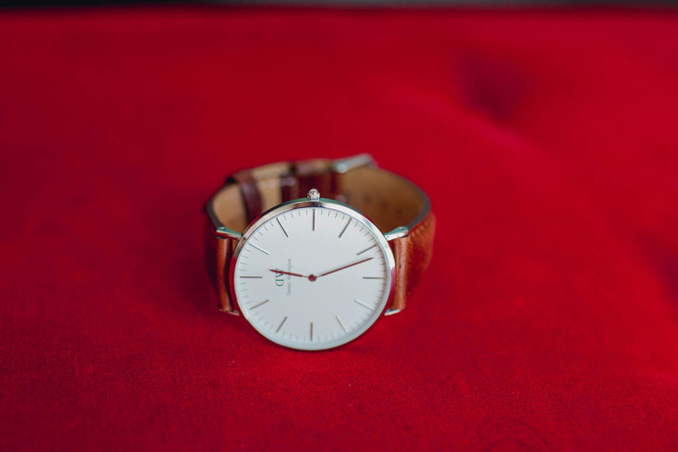 Groom's watch is set on red cushion, College of Charleston Cistern, South Carolina. Kate Timbers Photography. http://katetimbers.com