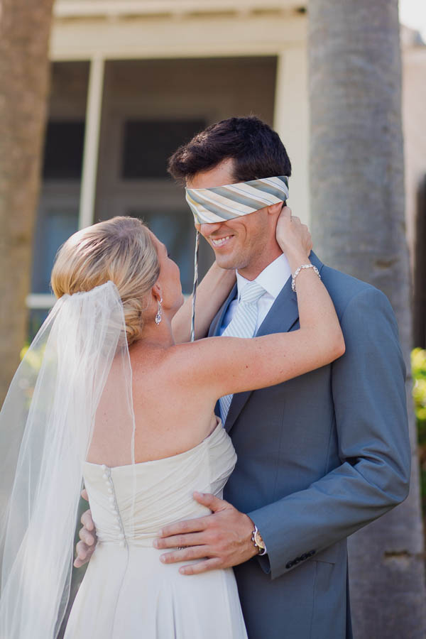 Groom is blindfolded during first meeting with bride, Cottages on Charleston Harbor, Mt Pleasant, South Carolina. Kate Timbers Photography. http://katetimbers.com