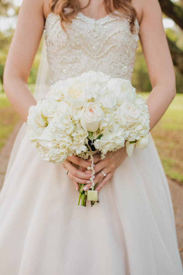 Bride holds bouquet, Brookgreen Gardens, Murrells Inlet, South Carolina. Kate Timbers Photography. http://katetimbers.com