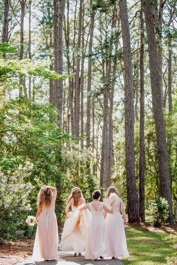 Bride and bridesmaids walk in forest, Brookgreen Gardens, Murrells Inlet, South Carolina. Kate Timbers Photography. http://katetimbers.com