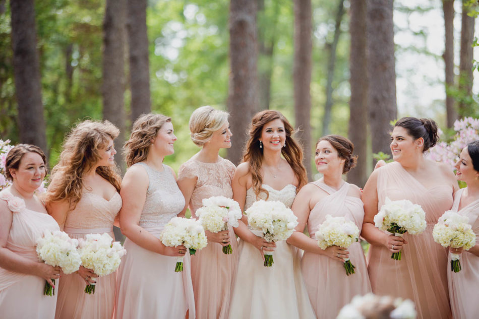 Bride and bridesmaids stand in row, Brookgreen Gardens, Murrells Inlet, South Carolina. Kate Timbers Photography. http://katetimbers.com