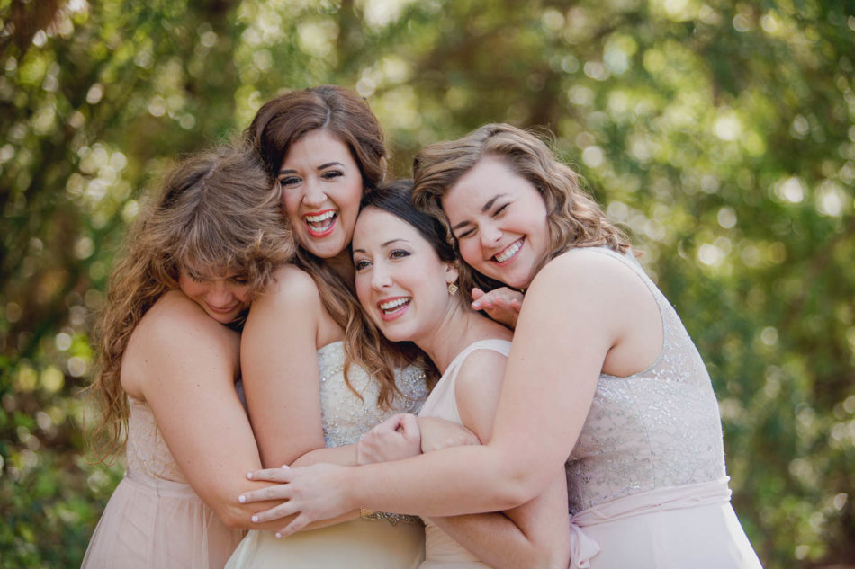 Bride hugs bridesmaids, Brookgreen Gardens, Murrells Inlet, South Carolina. Kate Timbers Photography. http://katetimbers.com