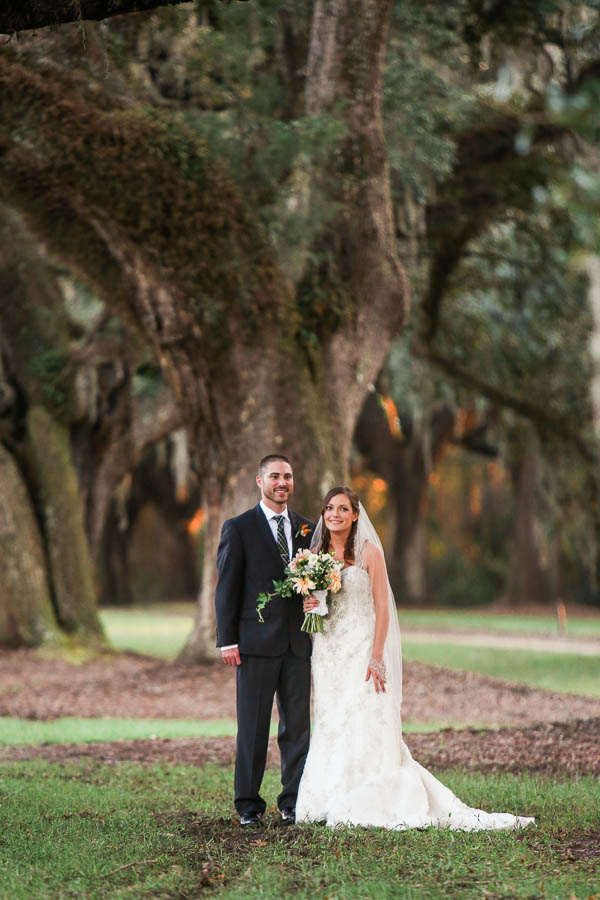 Bride and groom stand by oak tree, Boone Hall Plantation, Charleston, South Carolina. Kate Timbers Photography. http://katetimbers.com