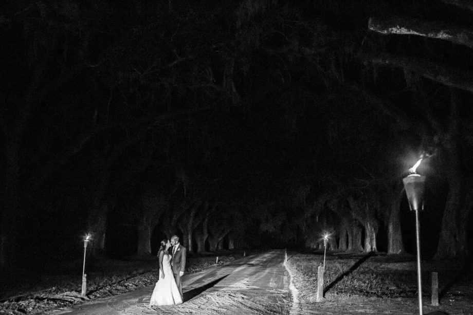 Bride and groom stand under avenue of oaks at night, Boone Hall Plantation, Charleston, South Carolina. Kate Timbers Photography. http://katetimbers.com