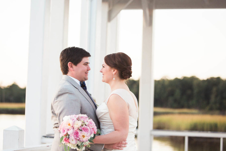 Bride and groom stand on dock at sunset, Creek Club at I'on, Charleston, South Carolina. Kate Timbers Photography. http://katetimbers.com