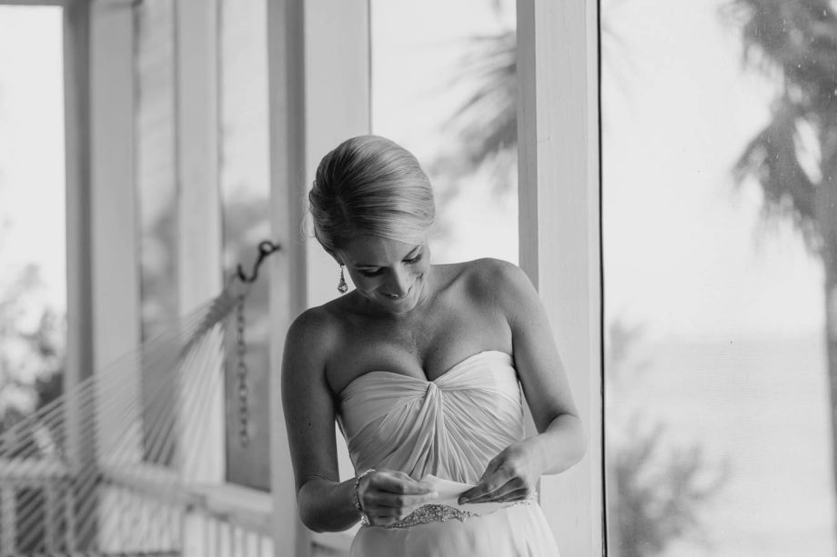 Bride reads groom's love note, Cottages on Charleston Harbor, Mt Pleasant, South Carolina. Kate Timbers Photography. http://katetimbers.com