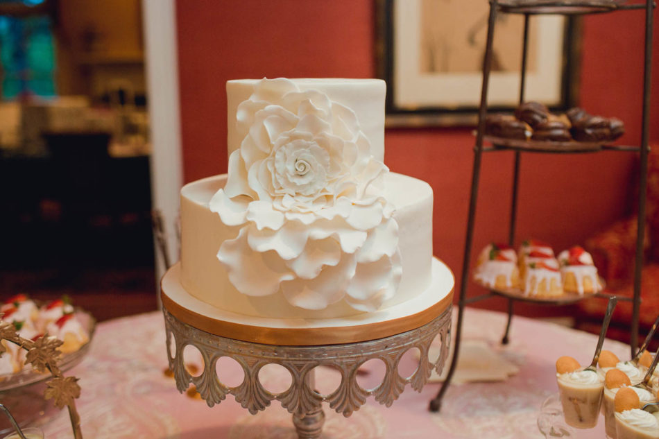 White cake has large flower decoration accent, Brookgreen Gardens, Murrells Inlet, South Carolina. Kate Timbers Photography. http://katetimbers.com