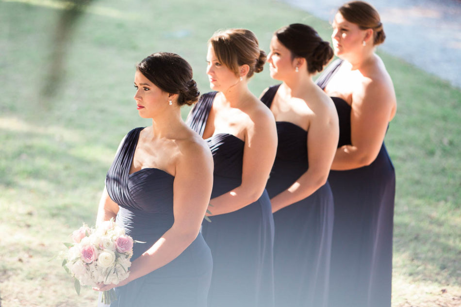 Bridesmaids stand in a row, Creek Club at I'on, Charleston, South Carolina. Kate Timbers Photography. http://katetimbers.com