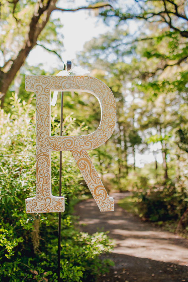 Bride and groom's initials hang by entrance of ceremony, Brookgreen Gardens, Murrells Inlet, South Carolina. Kate Timbers Photography. http://katetimbers.com