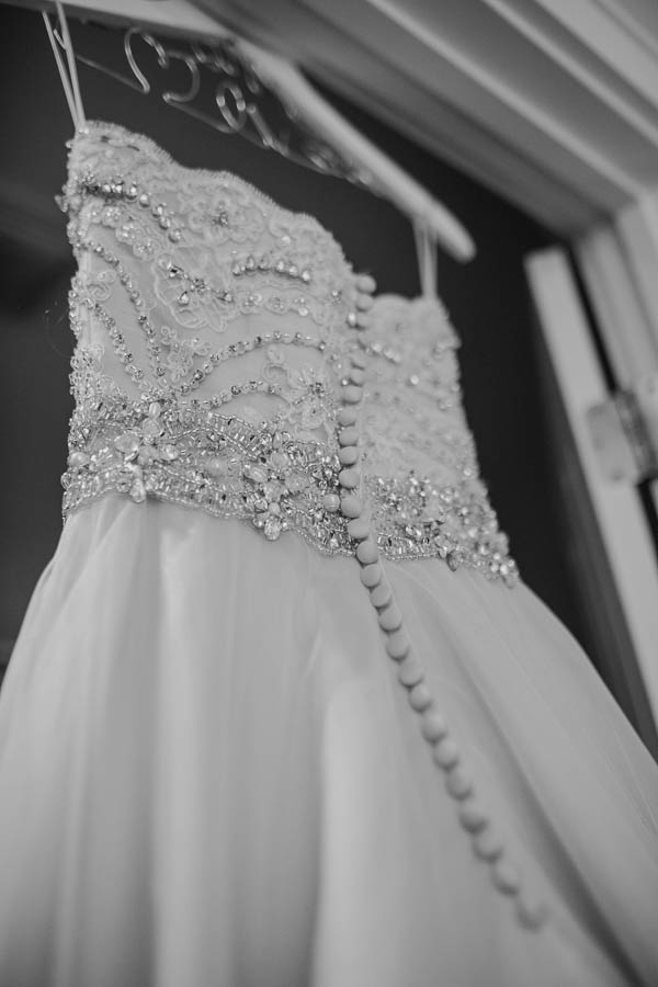 Wedding dress hangs on custom hanger, Brookgreen Gardens, Murrells Inlet, South Carolina. Kate Timbers Photography. http://katetimbers.com