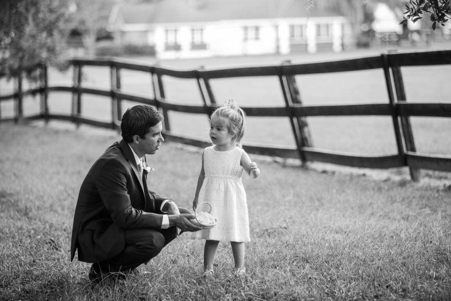 Groomsman talks to flowergirl, Boone Hall Plantation, Charleston, South Carolina. Kate Timbers Photography. http://katetimbers.com