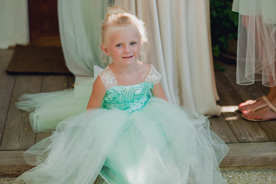 Flowergirl sits on step, Cottages on Charleston Harbor, Mt Pleasant, South Carolina. Kate Timbers Photography. http://katetimbers.com