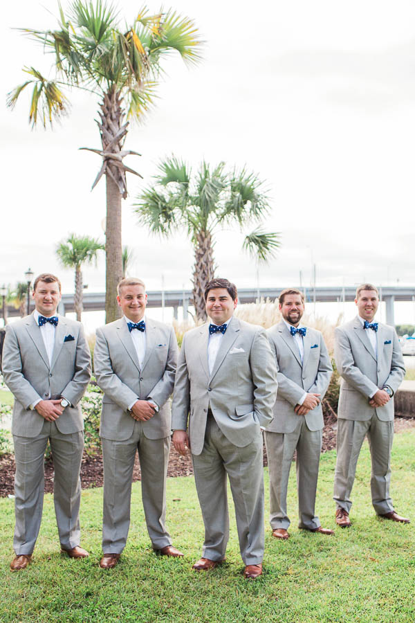 Groom and groomsmen stand by boatyard, Creek Club at I'on, Charleston, South Carolina. Kate Timbers Photography. http://katetimbers.com