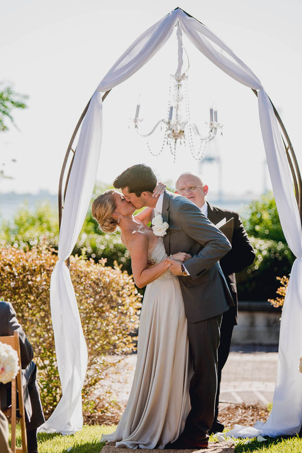 Bride and groom kiss, Harborside East, Mt Pleasant, South Carolina. Kate Timbers Photography. http://katetimbers.com