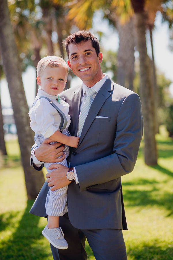 Groom holds ringbearer, Cottages on Charleston Harbor, Mt Pleasant, South Carolina. Kate Timbers Photography. http://katetimbers.com
