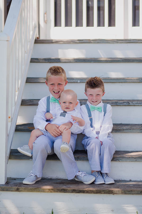 Ringbearers sit on steps, Cottages on Charleston Harbor, Mt Pleasant, South Carolina. Kate Timbers Photography. http://katetimbers.com