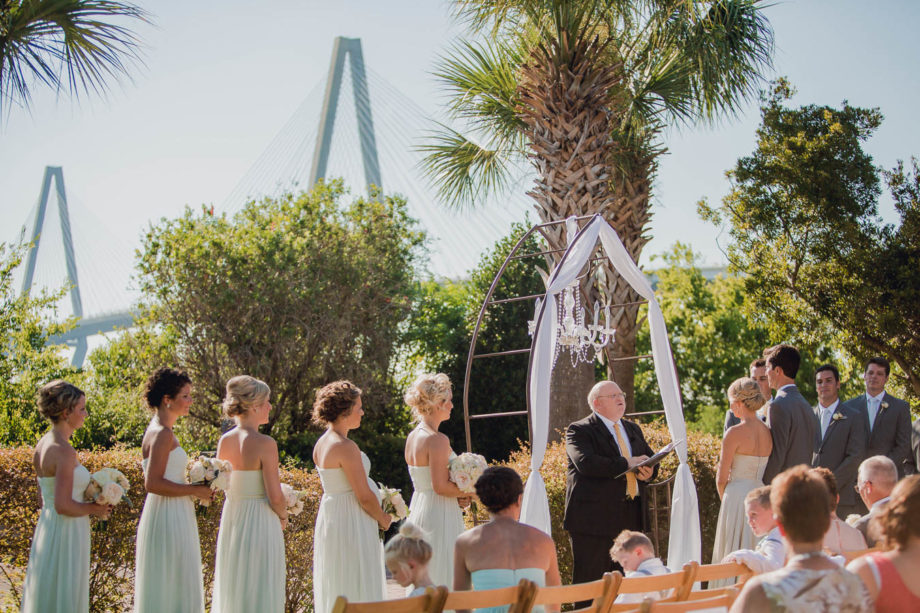 Bride and groom exchange vows with Ravenel Bridge in background, Harborside East, Mt Pleasant, South Carolina. Kate Timbers Photography. http://katetimbers.com