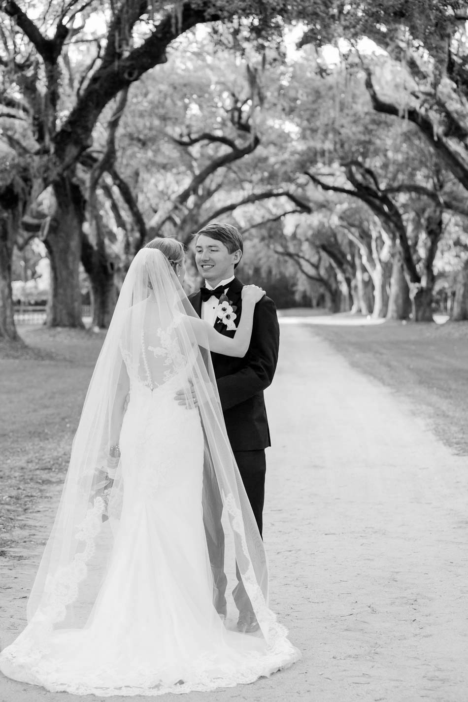 Bride and groom stand under avenue of oaks, Oakland Plantation, Mt Pleasant, South Carolina Kate Timbers Photography. http://katetimbers.com #katetimbersphotography // Charleston Photography // Inspiration