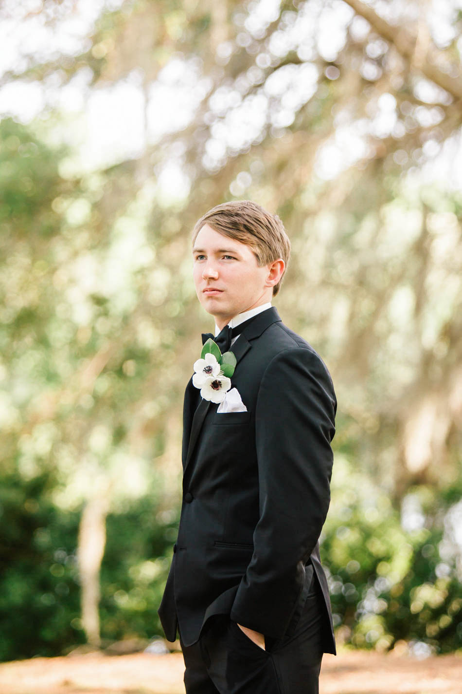 Groom stands under tree, Oakland Plantation, Mt Pleasant, South Carolina Kate Timbers Photography. http://katetimbers.com #katetimbersphotography // Charleston Photography // Inspiration